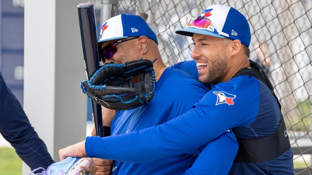 Blue Jays associate manager DeMarlo Hale, left, gets a hug from outfielder George Springer during Spring Training in 2024.