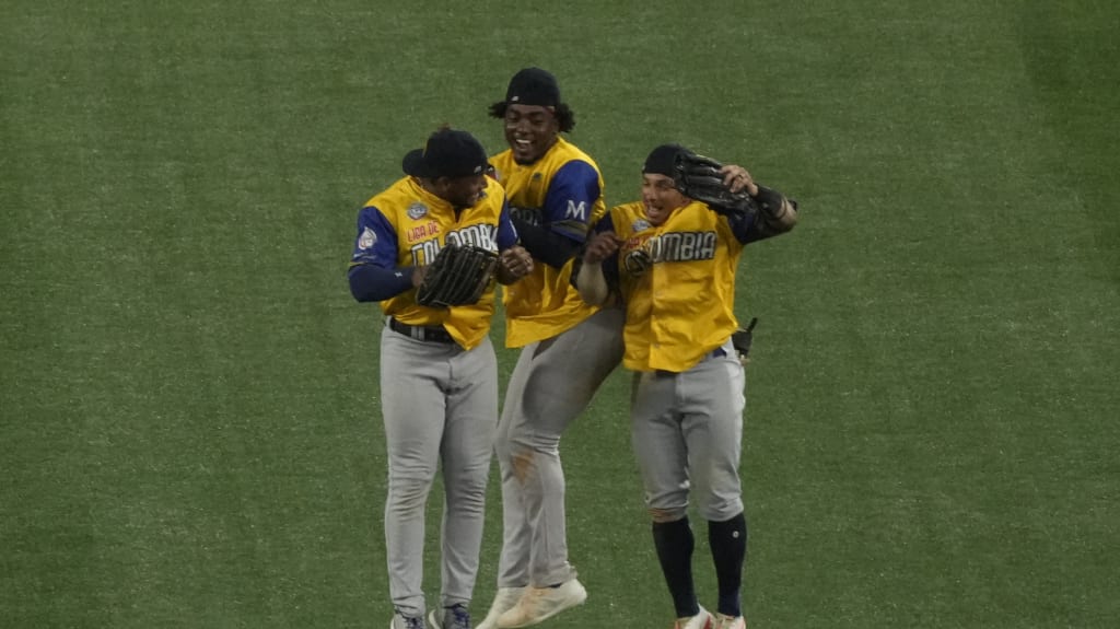 Colombia's outfielders celebrate after defeating the Dominican Republic. (Fernando Llano/AP)