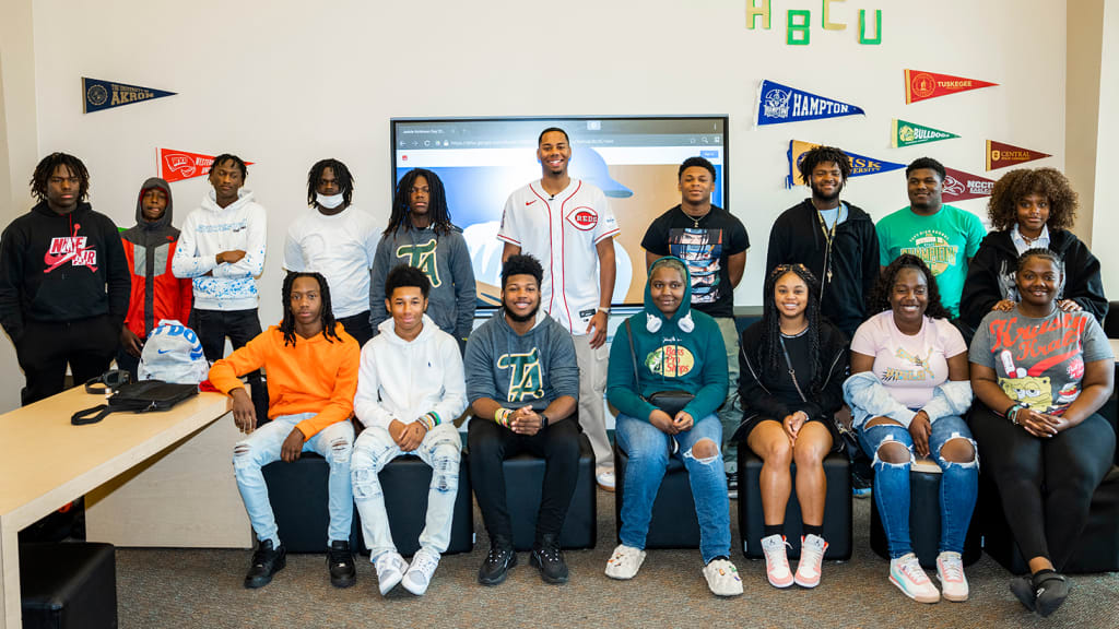 Eleven baseball players and six softball players take a group photo with Hunter Greene.