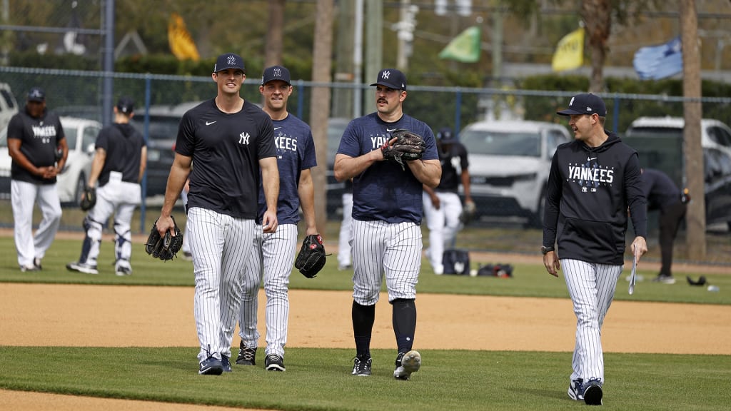 While Holmes [L] can sift through reams of data along with pitching coach Matt Blake [R], his signature two-seamer is still, he insists, more simple than teammates believe. “They seem pretty disappointed that I don’t have some secret for them,” Holmes says. (Photo Credit: New York Yankees)