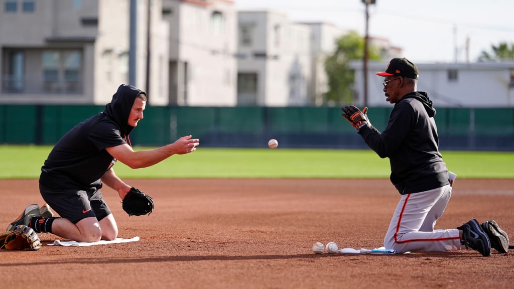 Ron Washington works with Giants third baseman Matt Chapman at Spring Training.