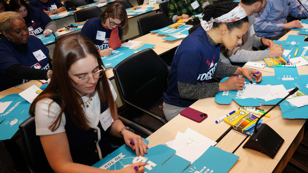 Participants decorate boxes during the MLB Together and Foster Love Packing Event at MLB Headquarters.