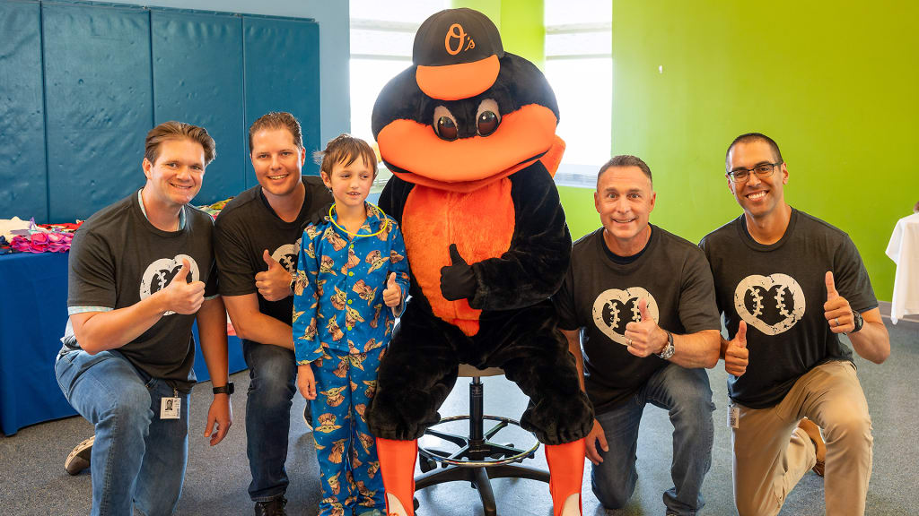 The Orioles' mascot joins umpires on a hospital visit.