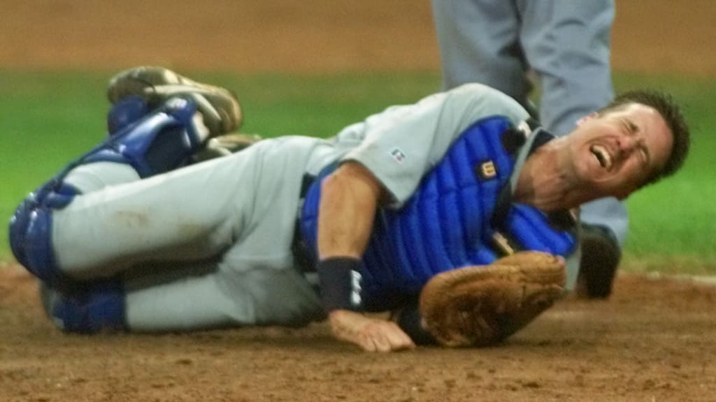Pat Borders writhes in pain after his collision in the Olympics.
