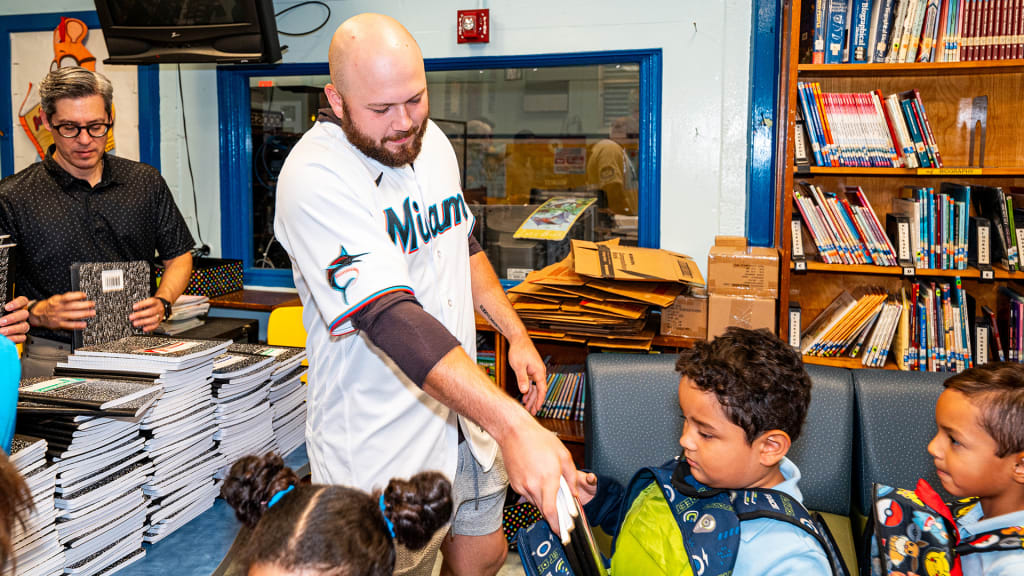 Jake Burger hands out school supplies at Kensington Park Elementary School. (Photo credit: Marlins)