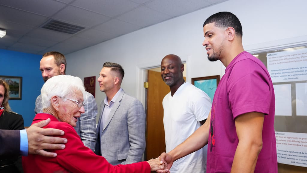 Mission Arlington Mission Metroplex founder Tillie Burgin speaks with MLB Commissioner Ambassador Dellin Betances at Globe Life Field during a workout day before the World Series on Friday, Oct. 27, 2023 in Arlington, Texas