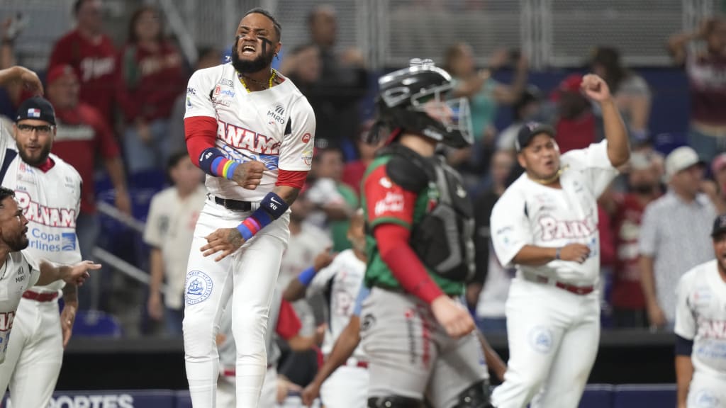 Panama's Allen Cordoba, left, celebrates after Johnny Yussef Santos hit an RBI triple to score the game-winning run during the ninth inning of a Caribbean Series game against Mexico.