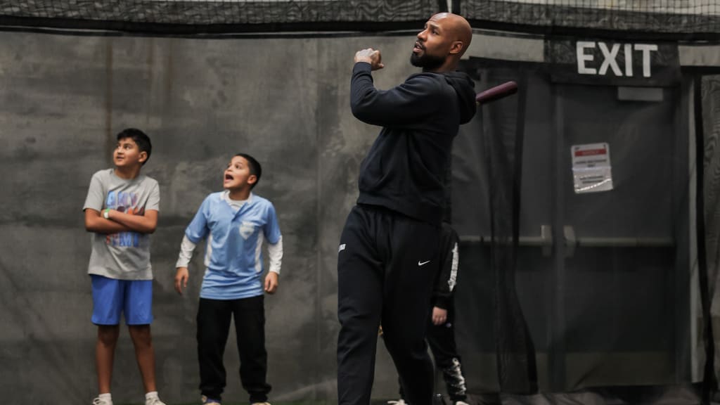 Heyward steps into the box and showcases his Major League swing for the kids at Saturday's baseball clinic in Chicago.