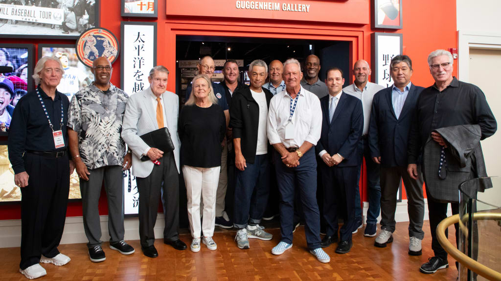 From left: Ted Simmons, Harold Baines, Peter O’Malley, Hall of Fame chairman Jane Forbes Clark, Jim Kaat, Jim Thome, Ichiro Suzuki, Cal Ripken Jr., George Brett, Fred McGriff, Hall of Fame president Josh Rawitch, John Smoltz, Hideo Nomo and Jack Morris stand outside the entrance to "Yakyu | Baseball: The Transpacific Exchange of the Game." (Milo Stewart Jr./National Baseball Hall of Fame and Museum)