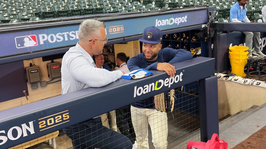 Jackson Chourio (right) talks with Brewers director of international player evaluation Luis Pérez during batting practice ahead of NLCS Game 2. (photo via Adam McCalvy)