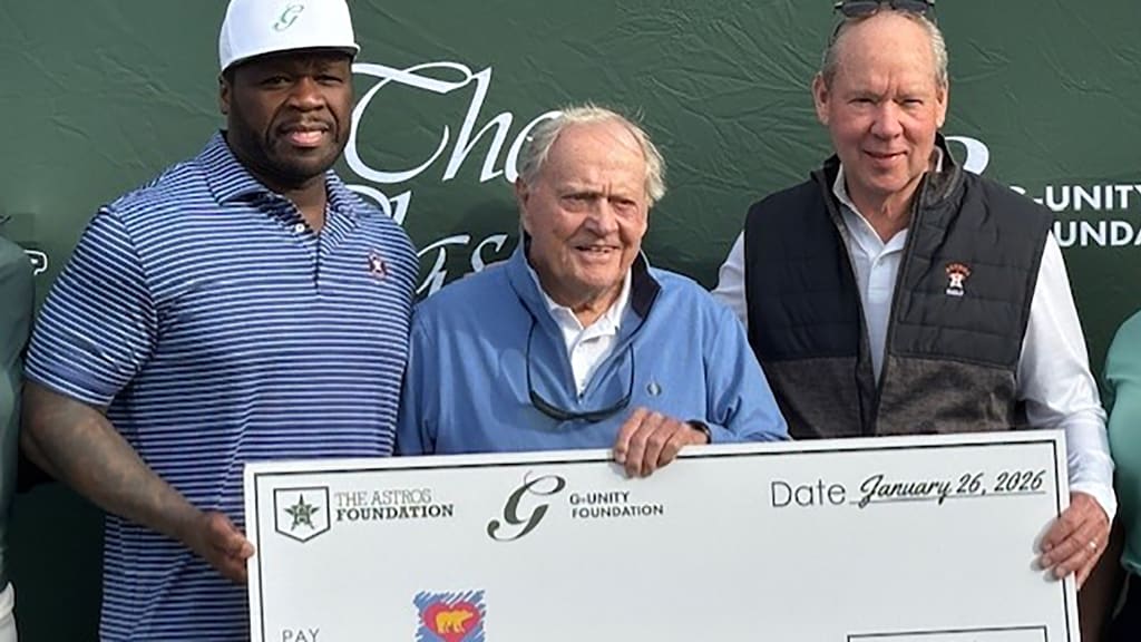Tournament co-hosts 50 Cent and Jim Crane present golf icon Jack Nicklaus with a check for his children’s healthcare foundation. (Brian McTaggart)