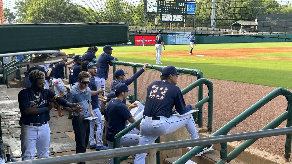 The Montgomery Biscuits occupy the third-base dugout. Chamberlain watches them from the first-base side.