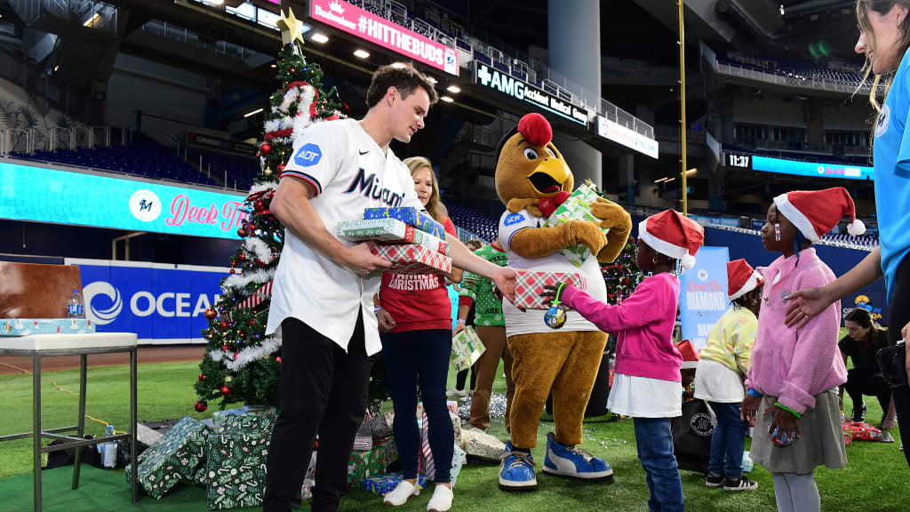 Griffin Conine hands out gifts at Marlins' Deck the Diamond event
