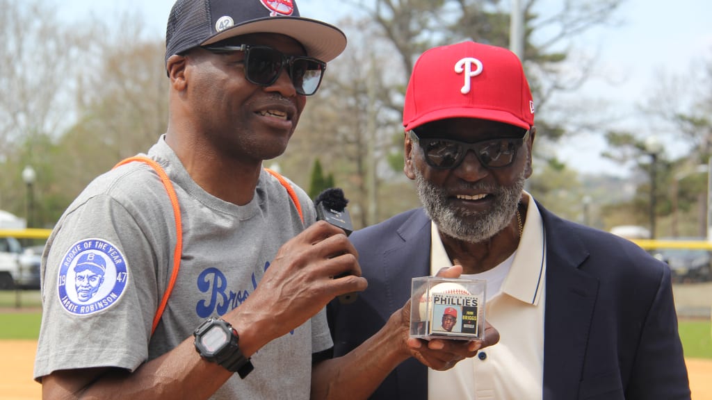 A Paterson resident holds up a ball signed by John Briggs in a case with a replica of his 1964 Topps rookie card.