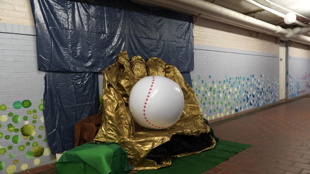 A gold glove created by the students at Tremont Montessori