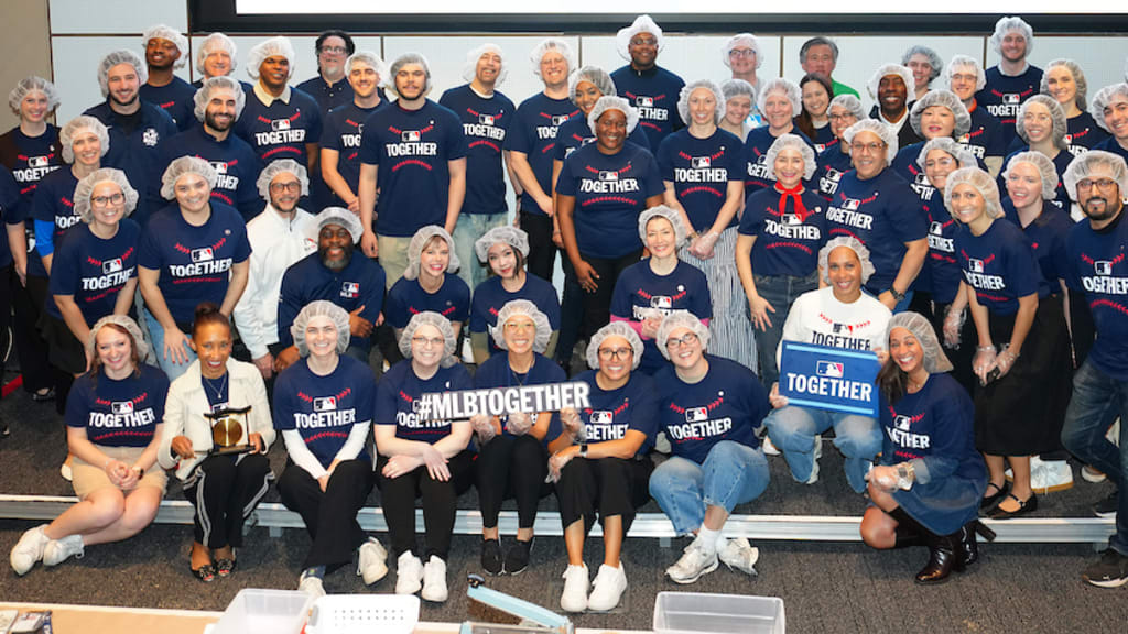 Employees pose for a group photo during the MLB Together volunteer event.