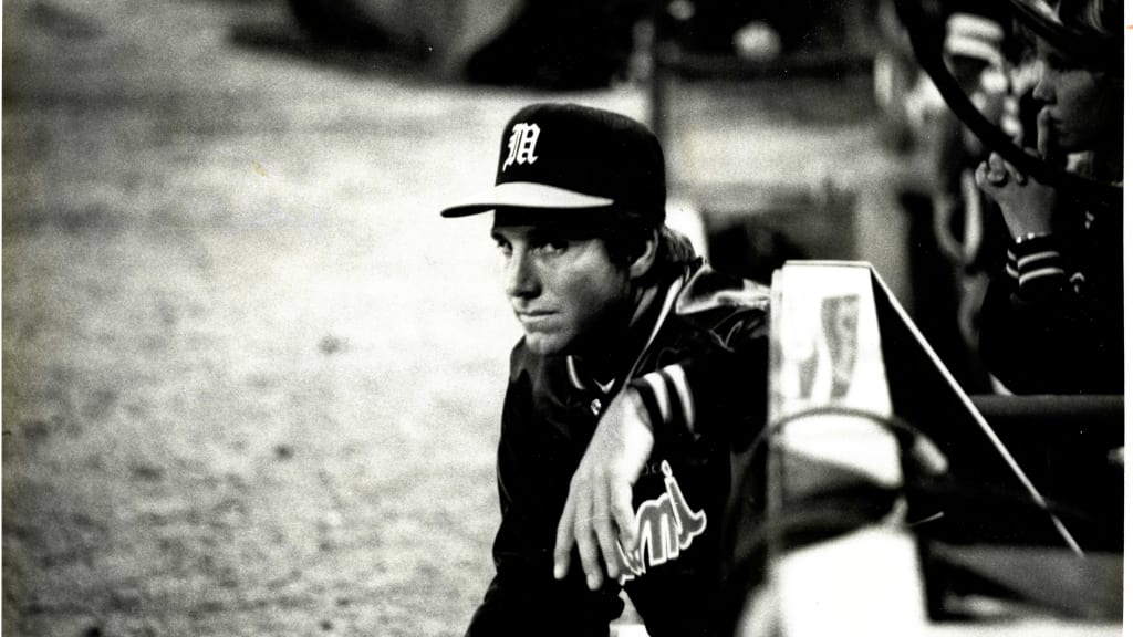 Coach Dave Scott peers out of the Miami dugout