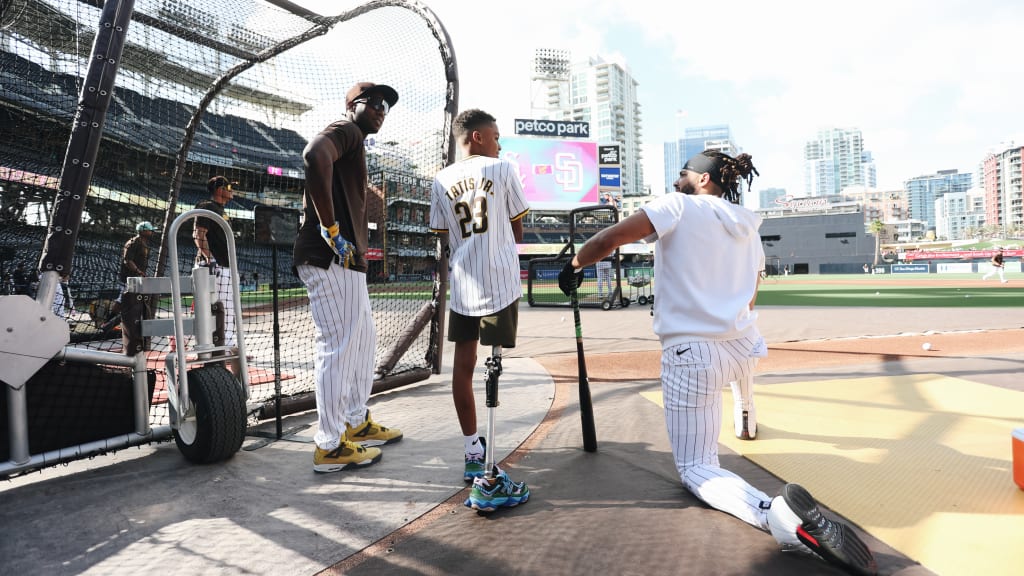Jurickson Profar and Fernando Tatis Jr. chat with Mikey Martinez during batting practice.