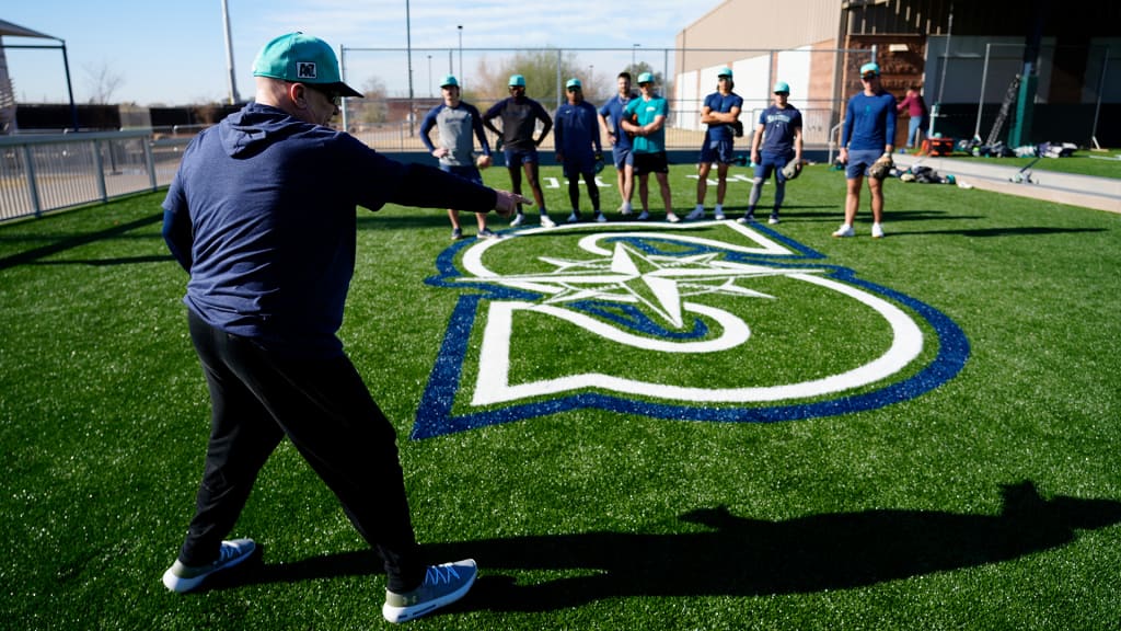 Perry Hill works with infielders at Seattle's upgraded training facility.