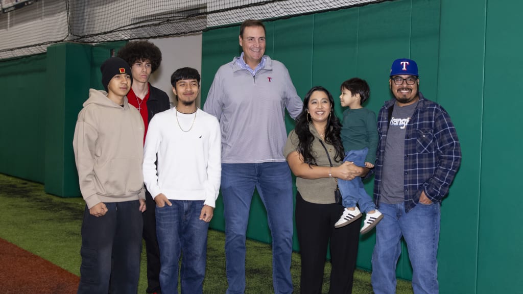 Chris Young, Texas Rangers President of Baseball Operations, posing for photos with families during the Texas Rangers Youth Academy Holiday Party on Dec. 16, 2025.