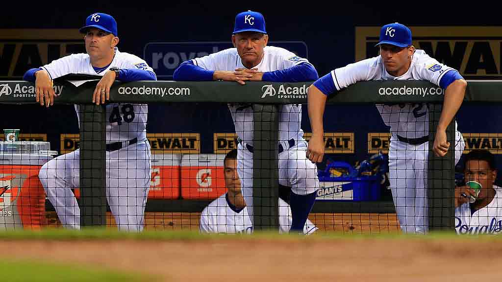 Pedro Grifol (left) and George Brett (center) take in a Royals game in 2013. (Photo via Getty Images)