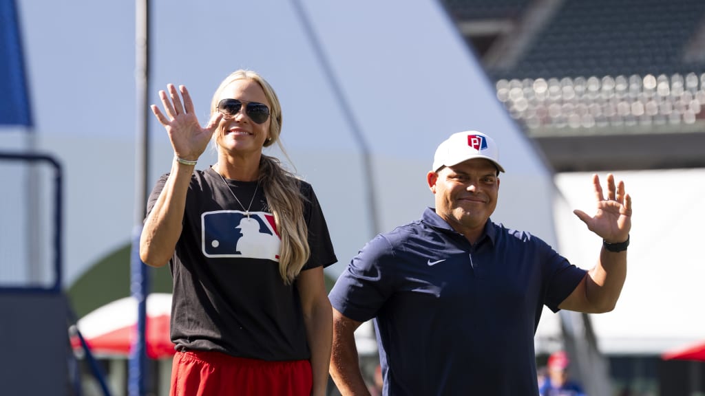 Softball legend Jennie Finch (left) waves to fans.