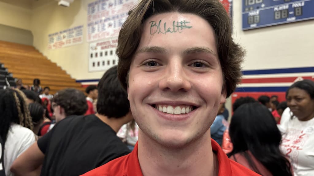 Brice Matthews autographed the forehead of fan during his jersey retirement ceremony.