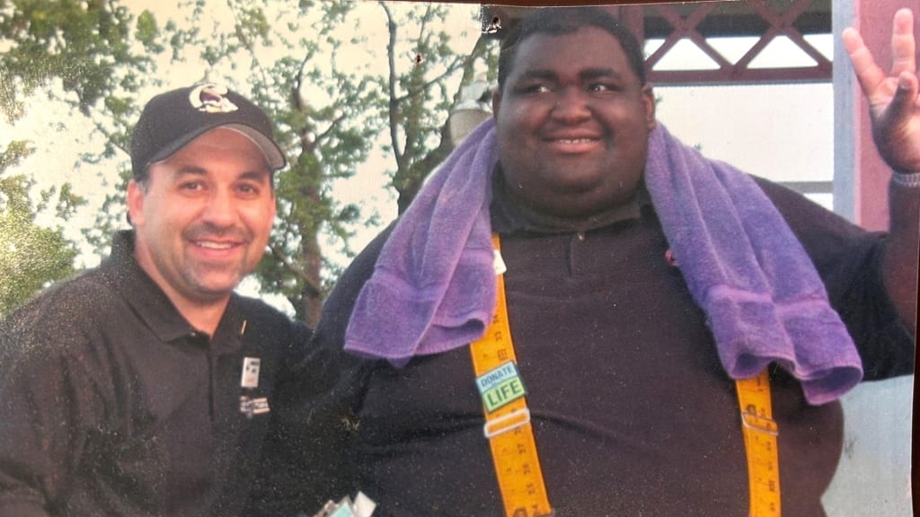 An archival photo of Rhashan alongside Crosscutters vice president of marketing Gabe Sinicropi.