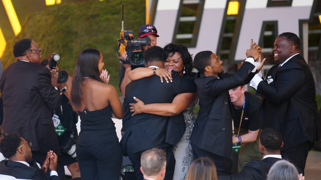 Kim Johnson hugs son Termarr while the rest of the family celebrates at the 2023 Draft.