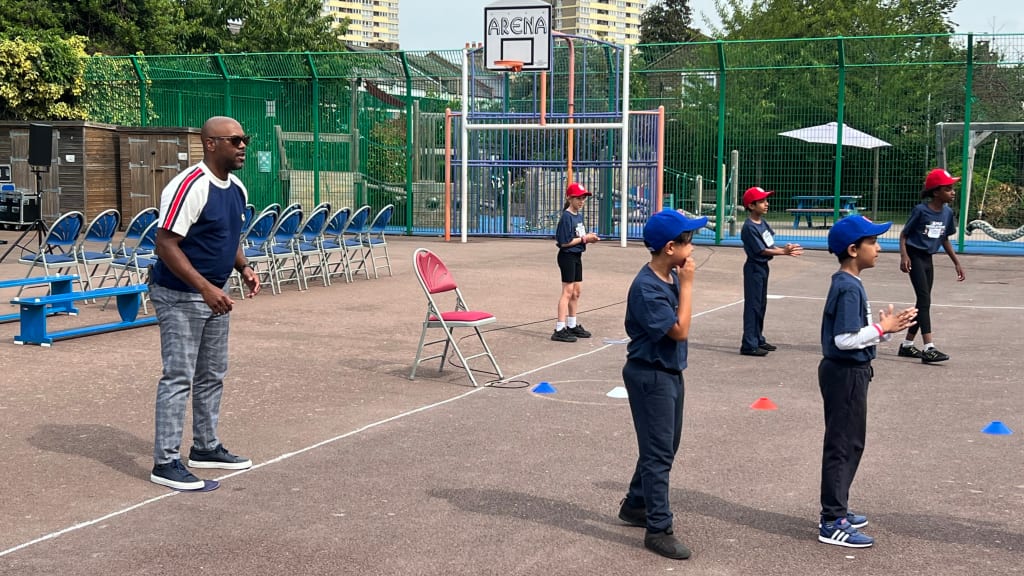 Jimmy Rollins gives instruction during the First Pitch Festival at Ranelagh Primary School.