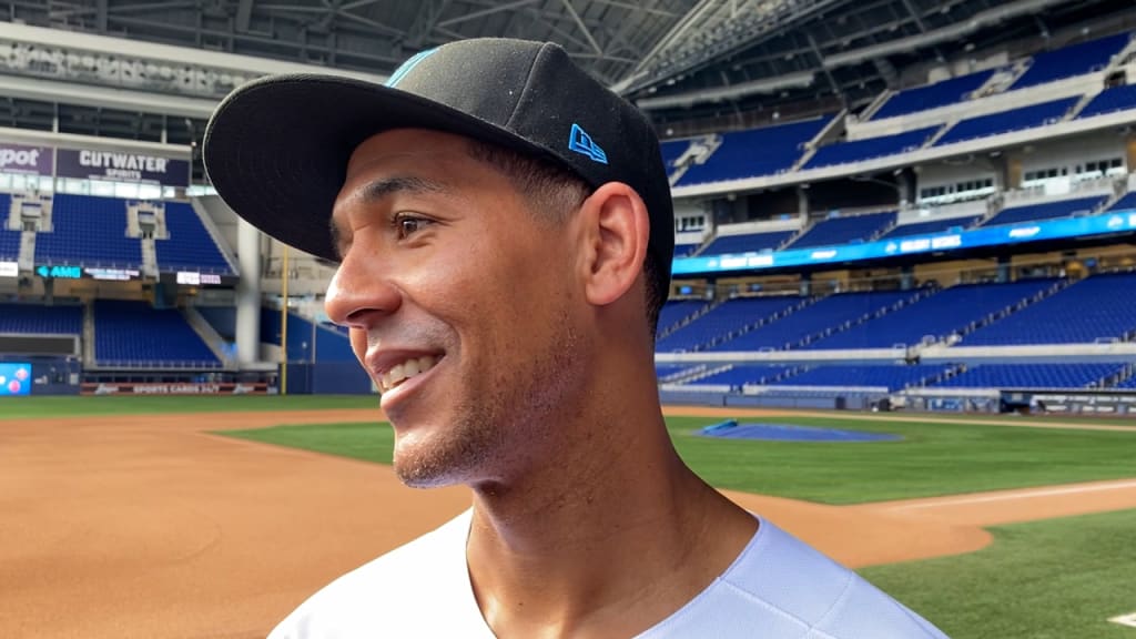 Jon Jay first base coach of the Miami Marlins holds his hat to his