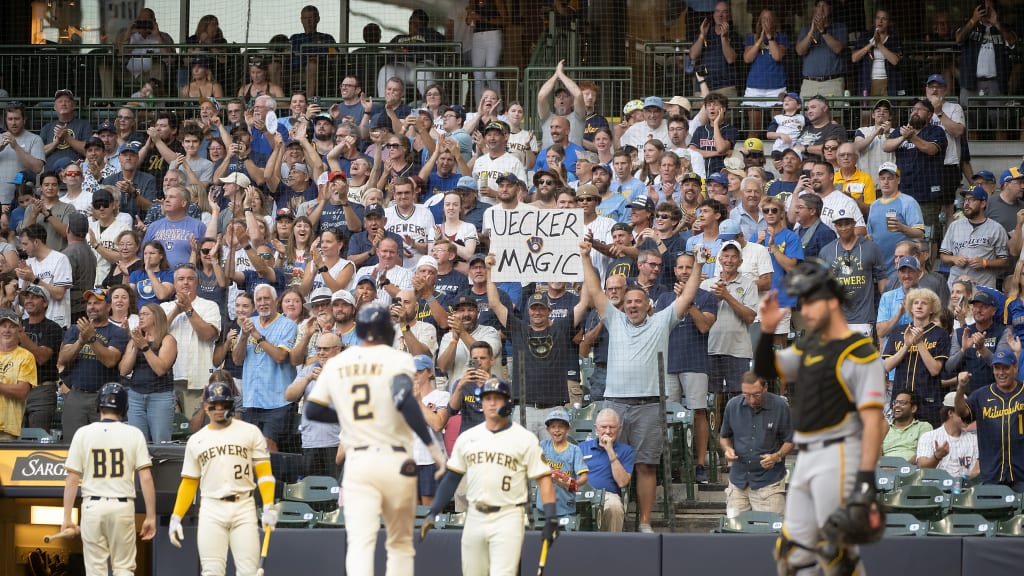 Brewers fan Frank Vitucci holds up his homemade "UECKER MAGIC" sign at Monday's win over the Pirates (Kirsten Schmitt/Brewers)