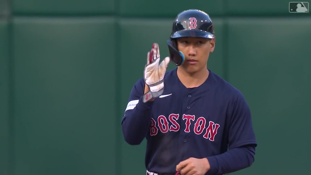 Trevor Story of the Boston Red Sox high-fives Rob Refsnyder after