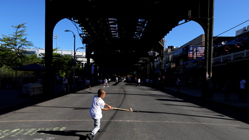 A young kid participates in a Play Ball stickball event outside Yankee Stadium in 2017 (Getty Images)