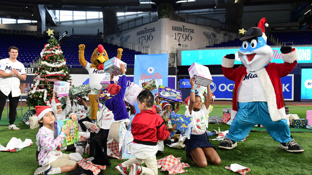 Children unwrap gifts at Marlins' Deck the Diamond event