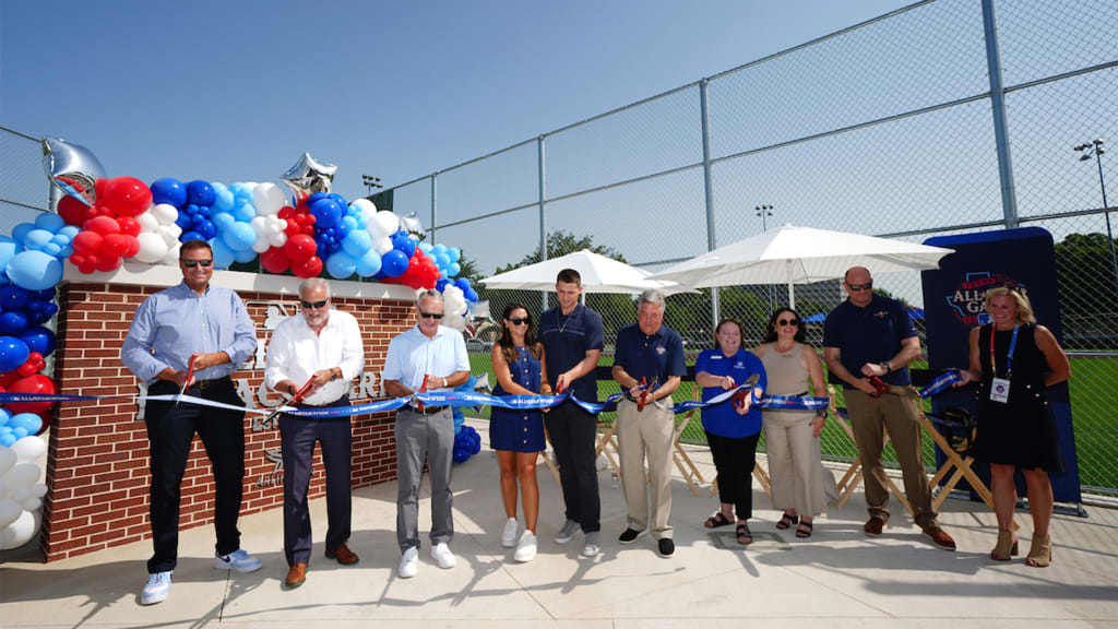 ARLINGTON, TX - JULY 15: Corey Seager, local leaders and executives cut the ribbon during the All-Star Legacy Park and Corey Seager Batting Cages Unveiling at Senter Park on Monday, July 15, 2024 in Arlington, Texas. (Photo by Daniel Shirey/MLB Photos via Getty Images)
