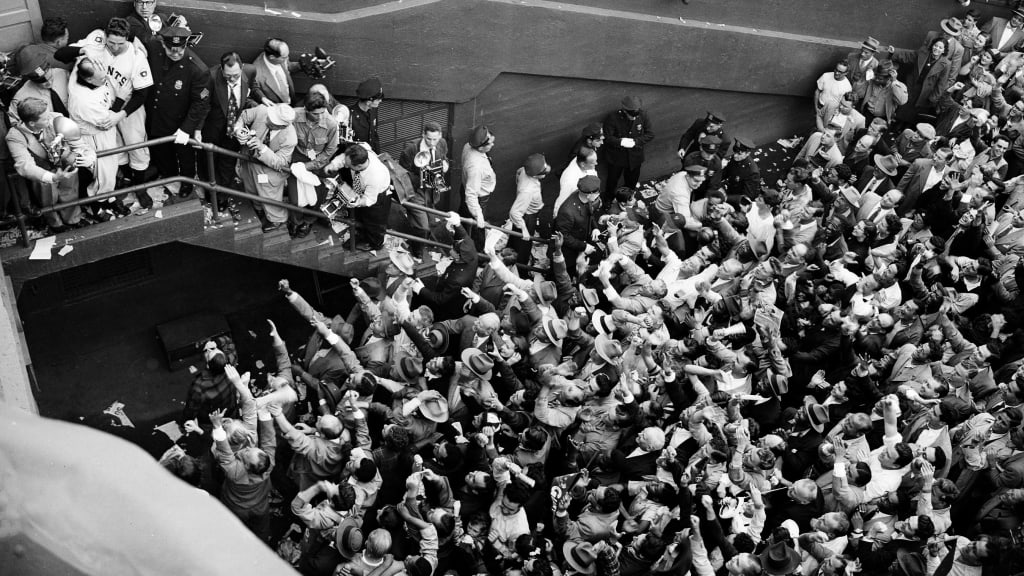 Bobby Thomson and manager Leo Durocher, top left, celebrate as the fans go wild.