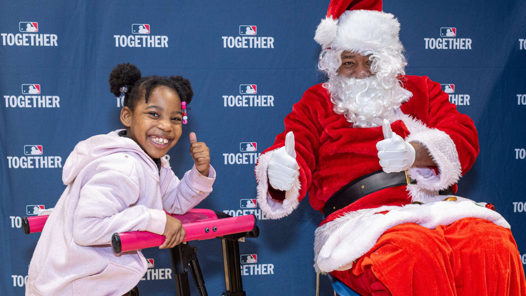 Santa celebrates the holiday season with one of the children during the 2025 Winter Wish holiday party at Madison Square Boys and Girls Club on Friday, Dec. 12, 2025, in New York. (Tom Salus/MLB Photos via Getty Images)