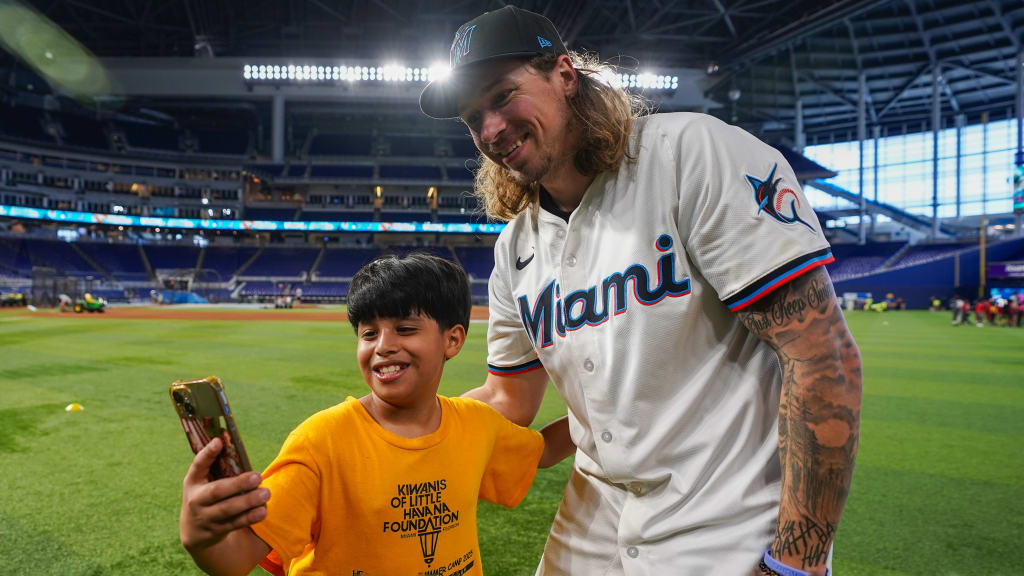 Lake Bachar interacts with a participant at the Marlins' P.L.A.Y. (Promoting a Lifetime of Activity for Youth) clinic.
