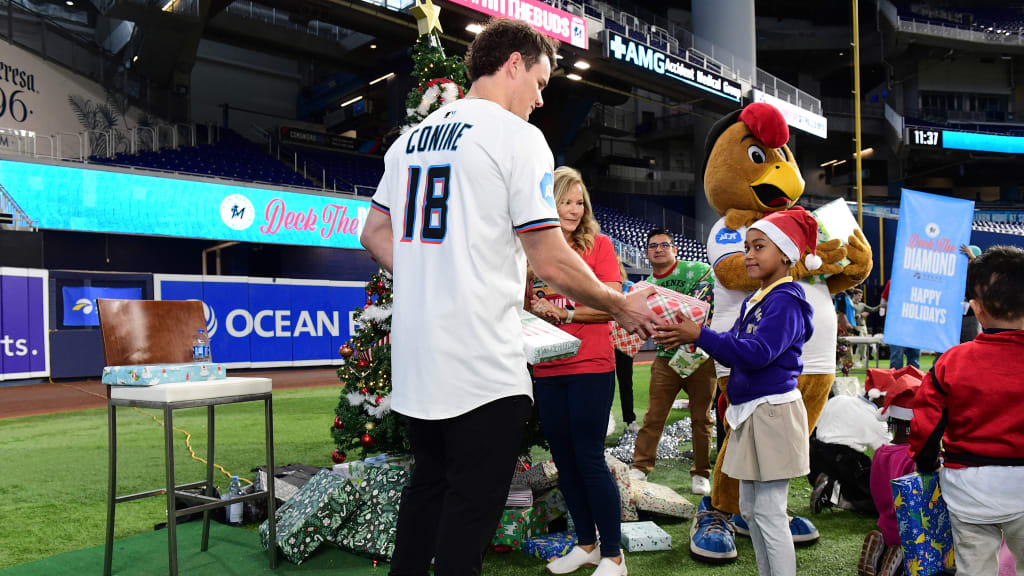 Griffin Conine hands out gifts at Marlins' Deck the Diamond event