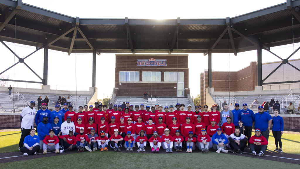 The Texas Rangers Youth Academy’s Martin Luther King Jr. Day Clinic athletes pose with Rangers players and alumni on Jan. 19.