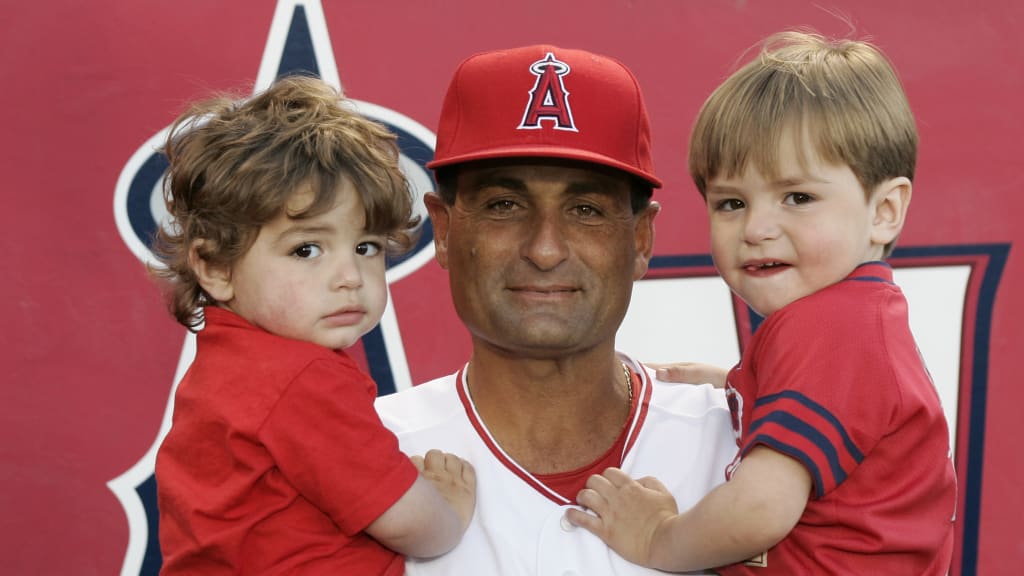 Dino Ebel holds his two sons, Trey and Brady (right).