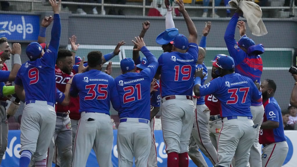 The Dominican Republic's Kevin Gutierrez, center, celebrates with his teammates after hitting a two-run home run against Mexico.