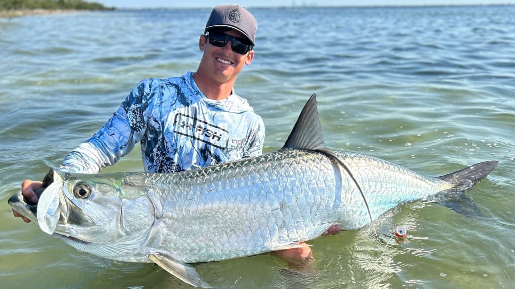 Charter fishing captain Jake Rogers poses with a tarpon. / Photo courtesy of Jake Rogers