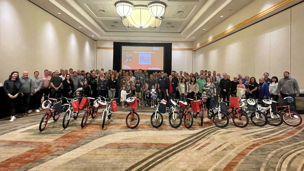 The group proudly displays the 14 bicycles built to benefit the Military Assistance Mission. (Texas Rangers)