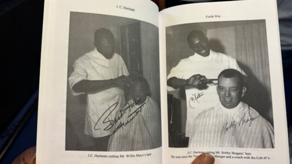 J C Hartman cutting the hair of Willie Mays