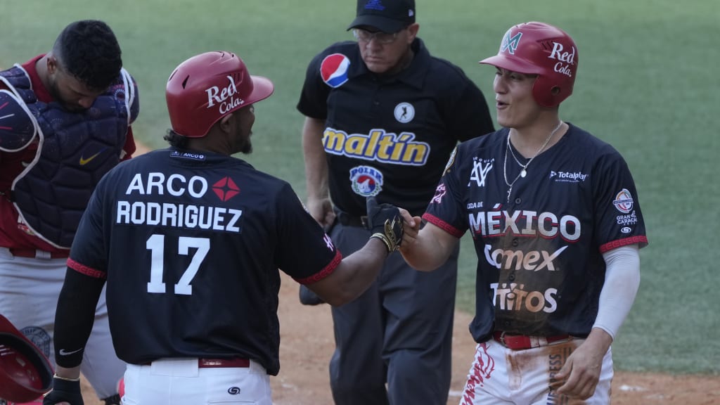 Mexico's Jose Cardona (right) celebrates with Reynaldo Rodriguez. (Ariana Cubillos/AP)