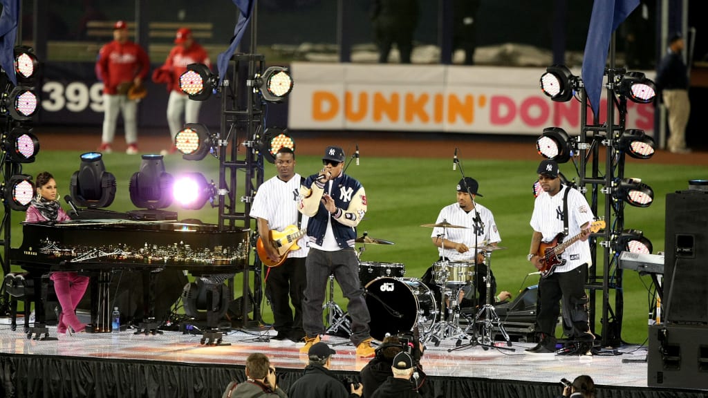 Alicia Keys at the piano and Jay-Z on the mic on a stage set up in the Yankee Stadium outfield. (Getty Images)