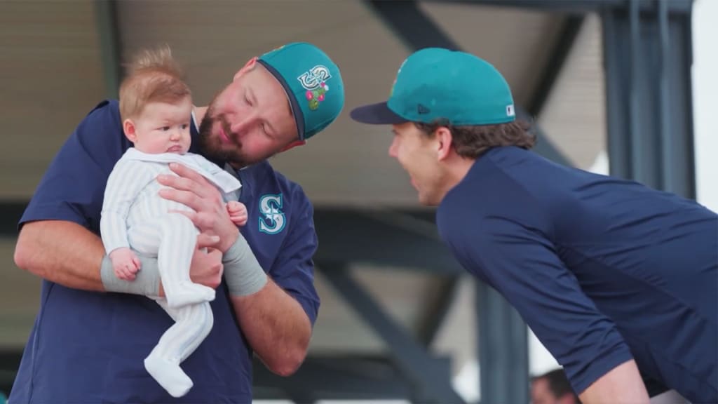 Cal Raleigh holding Logan Gilbert's child, Henry.