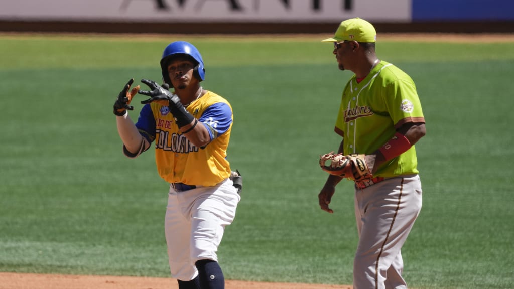 Colombia's Fernando Acuna (left) celebrates at second base on Monday. (Fernando Llano/AP)